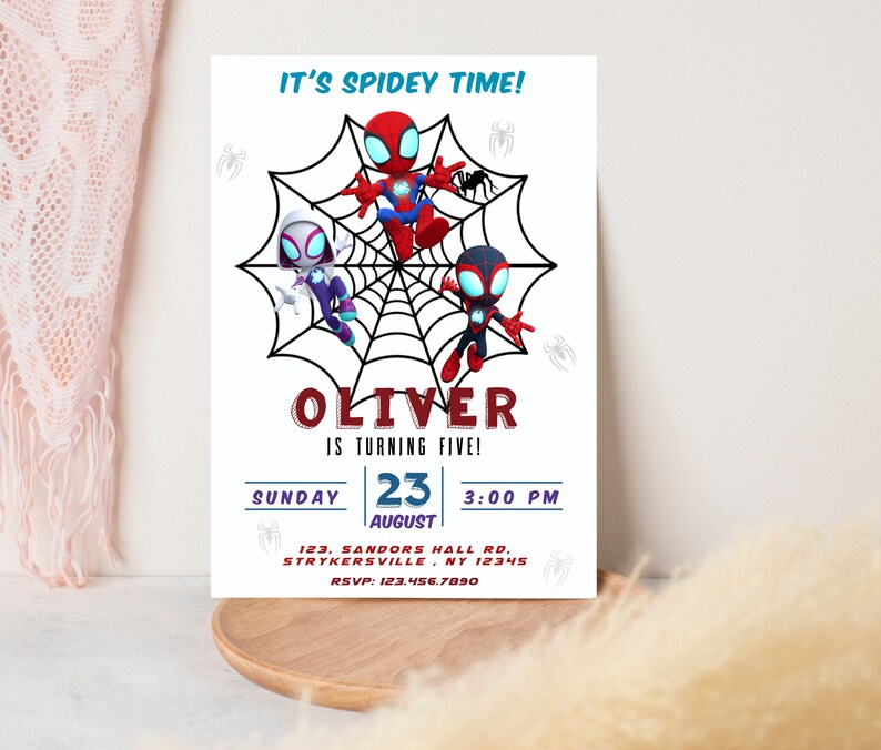 May include: A Spiderman-themed birthday party invitation with a red, black, and white cartoon Spiderman character on a web. The invitation says "It's Spidey Time!" and "Oliver is turning five!" with the date and time of the party.