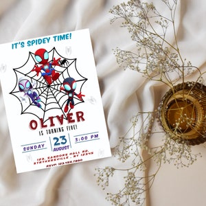 May include: A colorful invitation for a child's birthday party featuring a Spiderman theme. The invitation has a red, blue, and black color scheme and features three Spiderman characters. The text on the invitation reads "It's Spidey Time! Oliver is turning five! Sunday, August 23, 3:00 PM, 123 Sandors Hall Rd, Strykersville, NY 12345, RSVP: 123.456.7890."