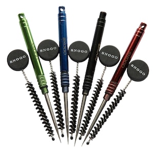 May include: Four cleaning tools in green, blue, black, and red, each with a brush and a round black disc with the word "SNOGO" in white. The tools have a metal handle and a brush at the end.