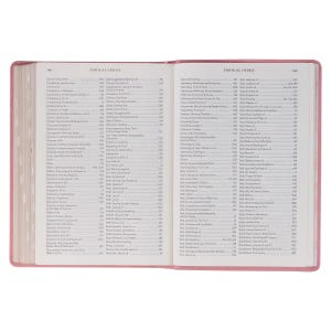 May include: Open Bible with a pink cover, displaying a detailed topical index. The pages are filled with small text, and the book is open to reveal the index. The text is in black, and the book is on a white background.