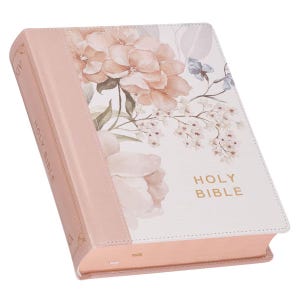 May include: A hardcover Holy Bible with a floral design. The cover features a light pink spine and edges, with a white front cover adorned with peach and pink flowers and the words "Holy Bible" in gold lettering.
