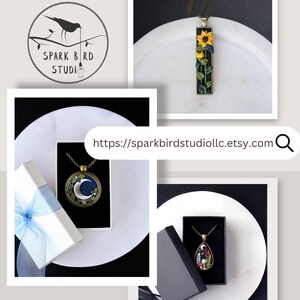 Spark Bird Studio collage featuring three handcrafted polymer clay necklaces: a yellow sunflower necklace, a crescent moon necklace with leaf accents, and a dark mushroom forest necklace. The Spark Bird Studio LLC logo and Etsy shop link appear beside them.
