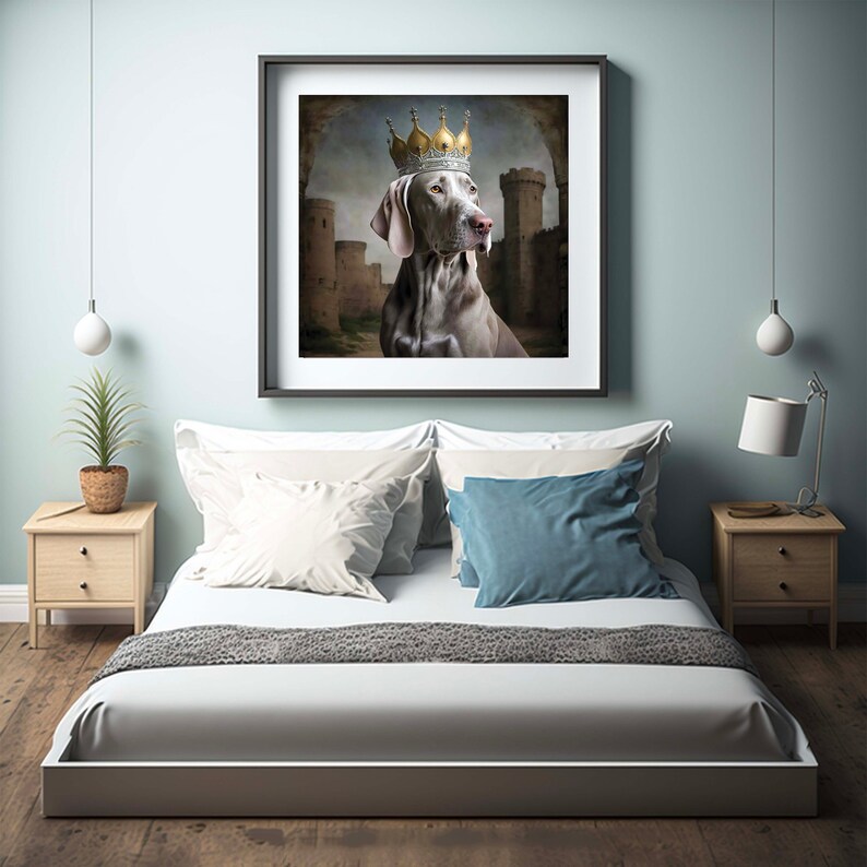 May include: A framed print of a dog wearing a gold crown, set against a backdrop of a medieval castle. The dog is looking to the right of the frame, with a serious expression. The print is hanging on a wall above a white bed with blue and white pillows.