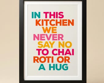 May include: A framed wall art print featuring the text IN THIS KITCHEN WE NEVER SAY NO TO CHAI ROTI OR A HUG in bold, multi-colored sans-serif lettering. The words are printed in teal, orange, pink, and yellow against a light cream background.