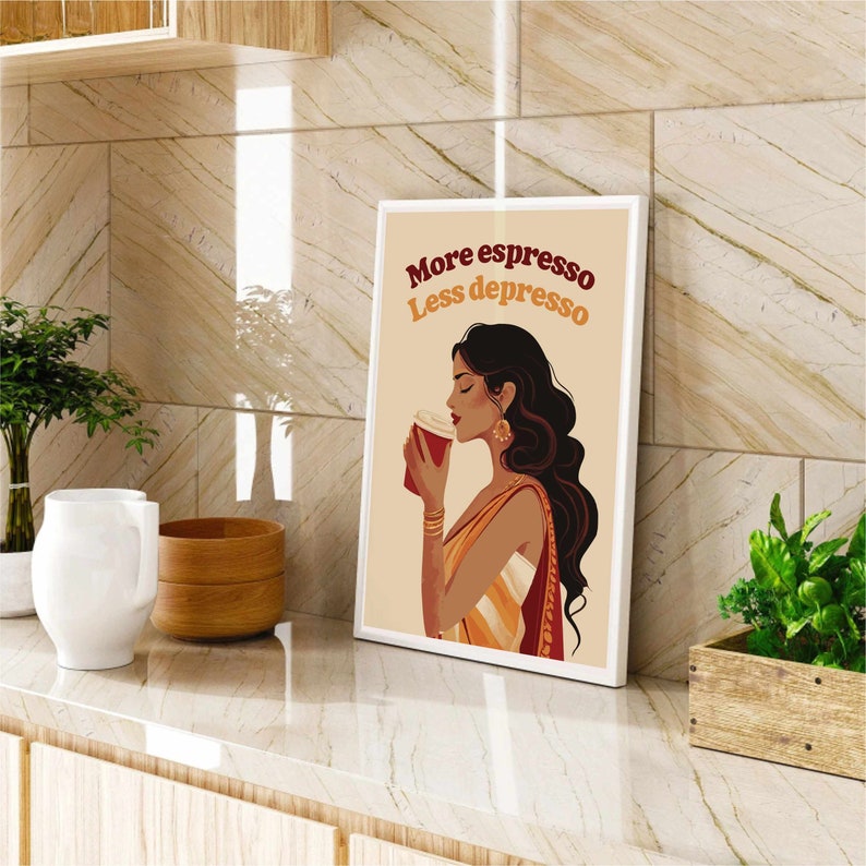 May include: A rectangular framed wall art print featuring a stylized illustration of a person with long dark hair holding a red coffee cup. The text "More espresso Less depresso" is printed in dark red and orange above the figure on a beige background.