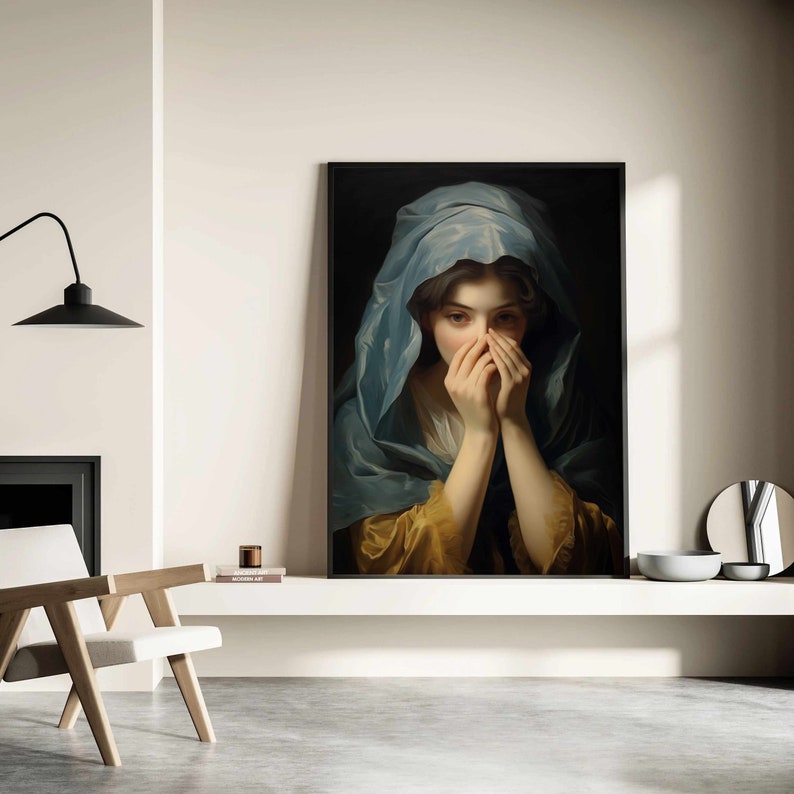 May include: A painting of a woman with her hands covering her face. She is wearing a blue shawl and a yellow dress. The painting is framed in black.