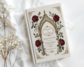 May include: A white wedding guest book featuring a gold gothic arch illustration, deep red roses, and green foliage. The text reads: Elora & Damien, Wedding Guest Book, Celebrating the Beginning of Our Forever, December 14, 2026, with gold corner accents.