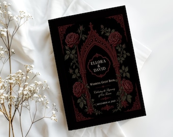 May include: A black wedding guest book featuring a dark red gothic archway illustration framed by blooming roses. The text reads: Ellora & David, Wedding Guest Book, Celebrating the Beginning of Our Forever, December 14, 2027, in white and gold.