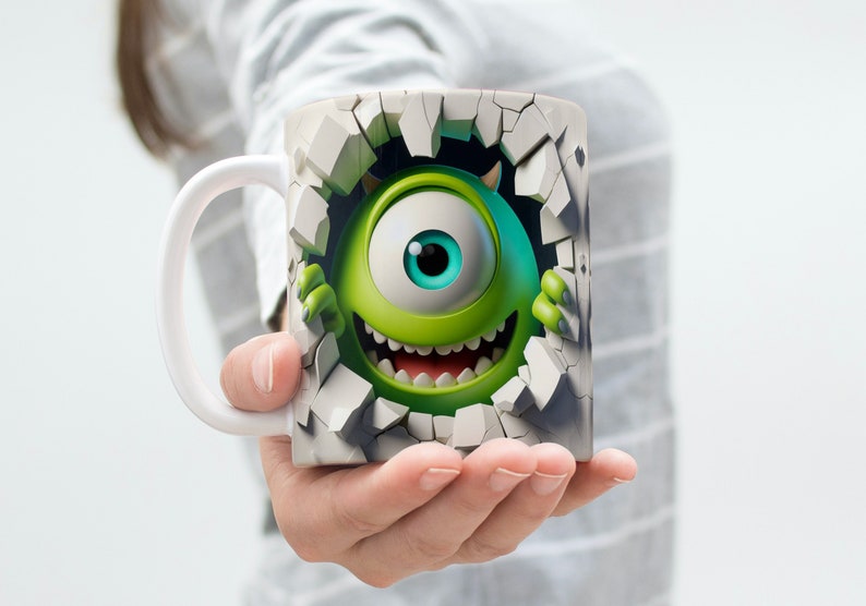 May include: A white ceramic mug with a green monster character breaking through a cracked wall design. The monster has one large eye and a toothy grin.