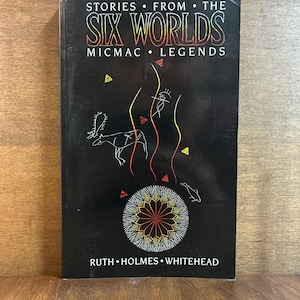 May include: A black book titled Stories From The Six Worlds Micmac Legends by Ruth Holmes Whitehead. The cover features a white and red line art illustration of a central mandala, a four-legged animal, a human figure, and small triangles.
