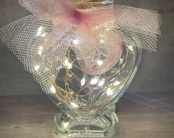 Mini heart shaped glass jar with cork lid and firefly lighting.  Cute gift for Valentine’s Day.  Classy wedding favor idea.
