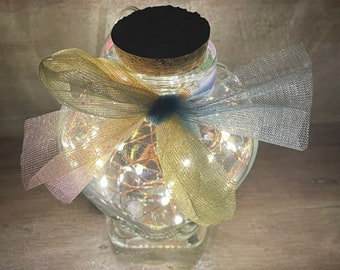 Super cute small heart shaped glass jar with cork lid and copper wire firefly lighting.  Classy wedding favor idea.  Valentine’s Day gift!!!