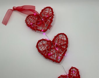 Valentine’s Day hanging heart decoration with pink lighting