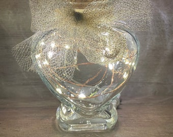 Super cute small heart shaped glass jar with cork lid and copper wire firefly lighting.  Classy wedding favor idea.  Valentine’s Day gift!!!