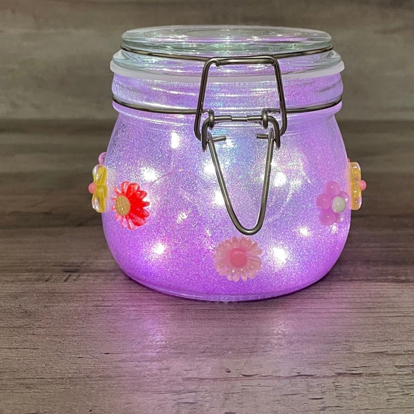 Absolutely gorgeous purple glittered hand crafted glass jar.  Finished off with floral accents and direly lighting.  Great gift idea!!