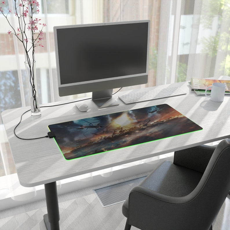 Centered prominently is a gaming desk mat, measuring 27.6 x 13.8, drawing attention to its impressive size. Adjacent to the mat, you'll find a sleek monitor, a cozy coffee cup, and a comfortable office chair, completing the inviting setup.