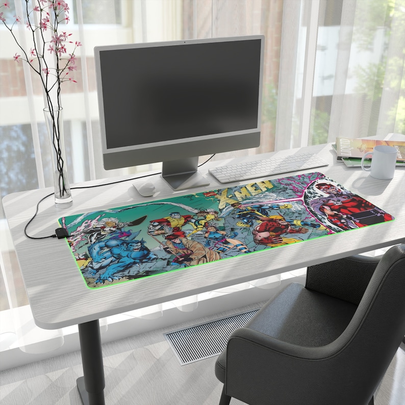 Centered prominently is a gaming desk mat, measuring 35.4 x 15.7, drawing attention to its impressive size. Adjacent to the mat, you'll find a sleek monitor, a cozy coffee cup, and a comfortable office chair, completing the inviting setup.