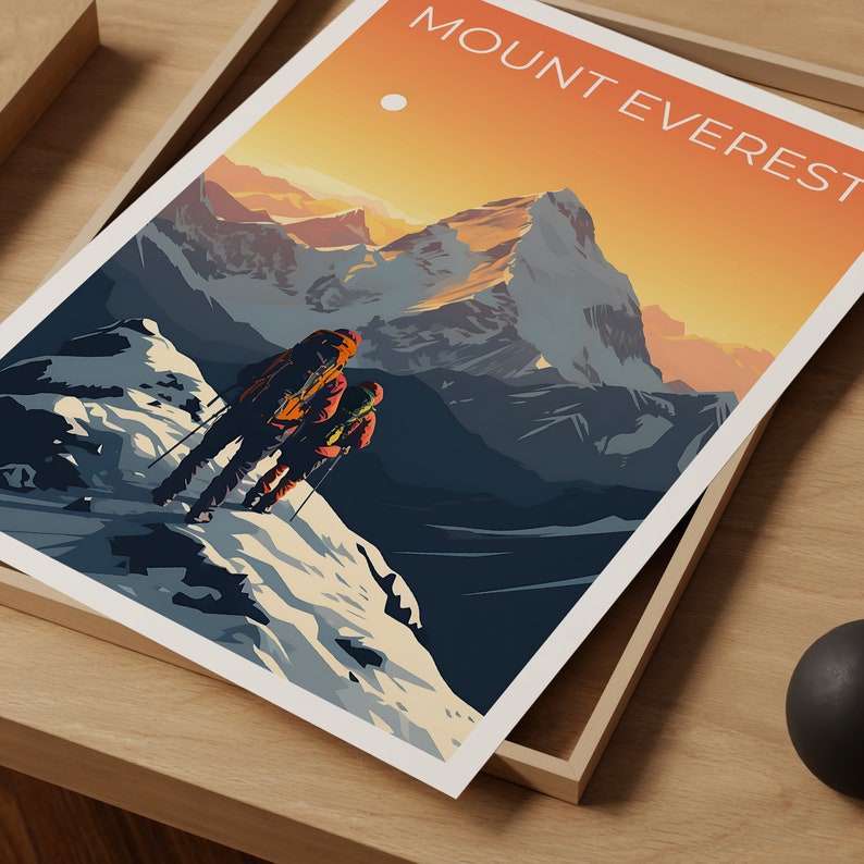May include: A framed art print featuring a stylized illustration of Mount Everest. The artwork depicts two figures ascending a snowy mountain slope, with the text "MOUNT EVEREST" at the top. The color palette includes orange, blue, and white.