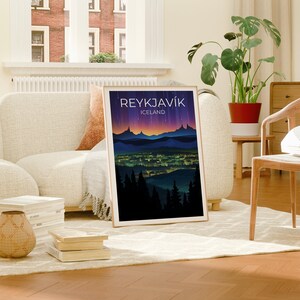 May include: A framed poster featuring a colourful illustration of a city skyline at night. The poster is titled "Reykjavik, Iceland".