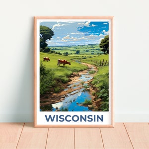 May include: A framed art print featuring a pastoral scene of Wisconsin. The artwork depicts a stream flowing through a green field with grazing cows under a blue sky. The word "WISCONSIN" is printed in navy blue at the bottom of the print.