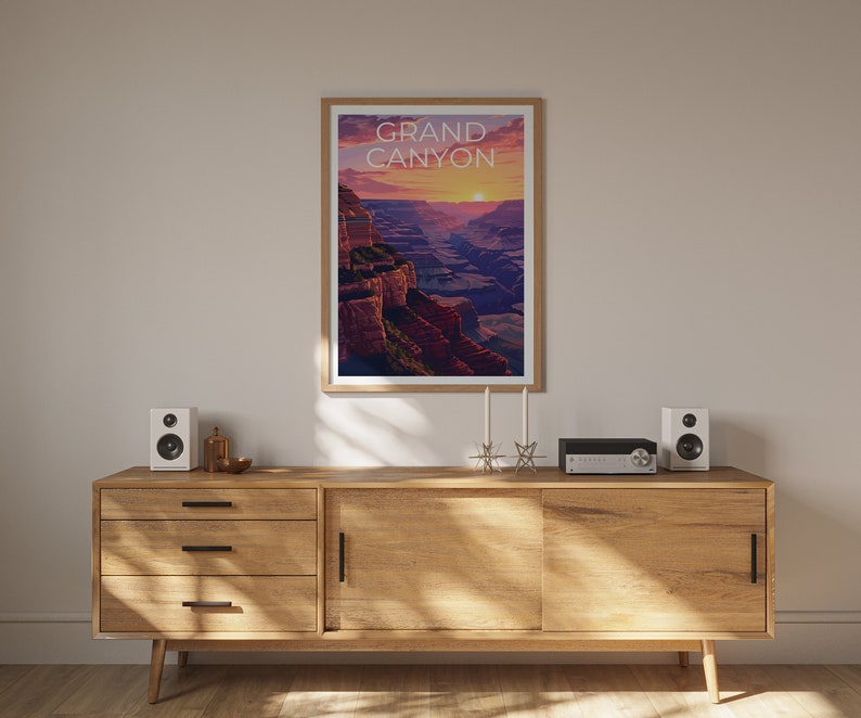 May include: A wooden dresser with three drawers and a cabinet door. The dresser is in a room with a framed poster of the Grand Canyon with the text "GRAND CANYON" on it. There are two white speakers on the dresser, a small silver object, and a black stereo.