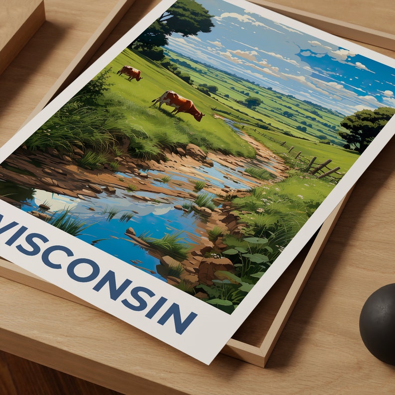 May include: A landscape print featuring a vibrant green pasture with two cows grazing. A stream flows through the scene, reflecting the sky. The word "WISCONSIN" is printed in blue at the bottom of the print.