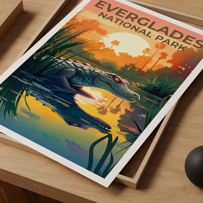 May include: A vintage-style poster with a sunset scene featuring an alligator swimming in a swamp. The poster has the text "Everglades National Park" in a bold, white font.