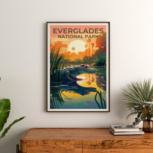 May include: A vintage-style poster with the text "Everglades National Park" in brown lettering. The poster features a green alligator swimming in a body of water with a sunset in the background.