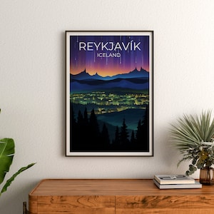 May include: A poster featuring a graphic design of the city of Reykjavik, Iceland. The poster depicts a cityscape with a mountain range in the background and a purple and pink sky with stars. The text "REYKJAV&Iacute;K" and "ICELAND" is printed on the poster.