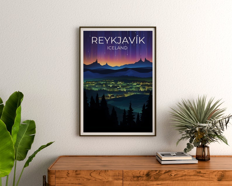 May include: A poster featuring a graphic design of the city of Reykjavik, Iceland. The poster depicts a cityscape with a mountain range in the background and a purple and pink sky with stars. The text "REYKJAV&Iacute;K" and "ICELAND" is printed on the poster.