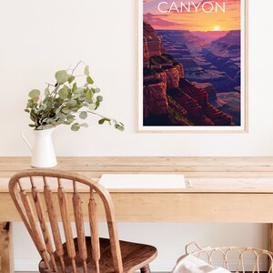May include: A framed poster with a sunset view of the Grand Canyon. The poster has the text "GRAND CANYON" in white letters on a light brown background.