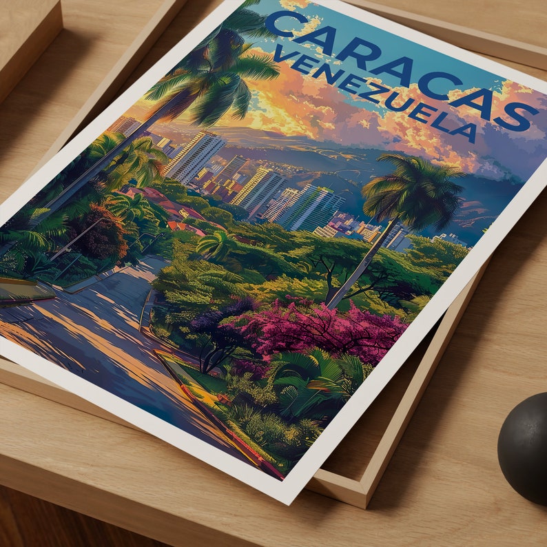 May include: A vintage travel poster featuring a scenic view of Caracas, Venezuela. The poster depicts a winding road leading up to a cityscape with lush green trees and palm trees. The text "CARACAS VENEZUELA" is displayed in a bold blue font at the top of the poster.