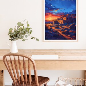 May include: A framed poster with a sunset scene of a building in the desert. The poster has the text "NEW MEXICO" at the top.