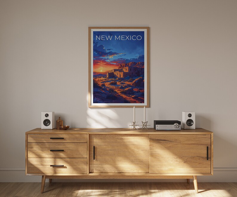 May include: A framed poster with a sunset scene and the text "NEW MEXICO" in white. The poster is hanging on a wall above a wooden cabinet with two speakers and a stereo system.