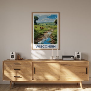 May include: A framed art print featuring a scenic landscape of Wisconsin. The artwork depicts a river flowing through a green pasture with cows grazing. The word "WISCONSIN" is printed in blue at the bottom of the print.