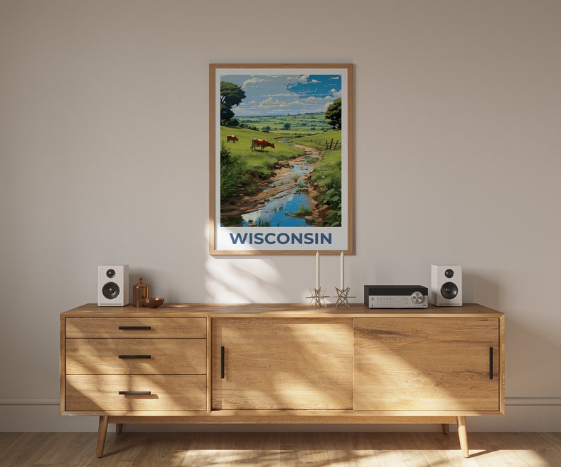 May include: A framed art print featuring a scenic landscape of Wisconsin. The artwork depicts a river flowing through a green pasture with cows grazing. The word "WISCONSIN" is printed in blue at the bottom of the print.