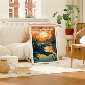 May include: A vintage-style poster with an illustration of an alligator in a swamp at sunset. The poster reads "Everglades National Park".