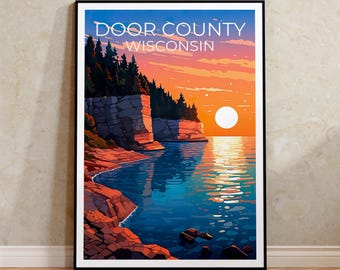 May include: A framed art print featuring a scenic view of Door County, Wisconsin. The artwork depicts a sunset over a lake with rocky cliffs, trees, and the text "Door County Wisconsin" in white letters against a blue sky.