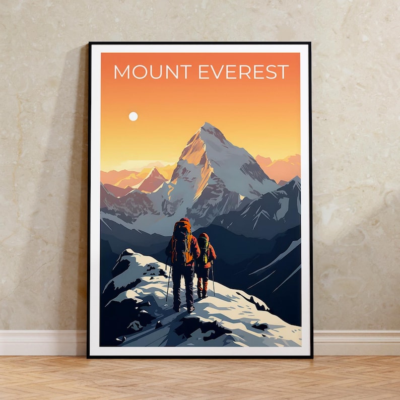 May include: A framed print featuring a stylized illustration of Mount Everest. The artwork depicts two hikers ascending a snowy ridge, with the mountain peak and a sunset sky in the background. The words "MOUNT EVEREST" are at the top.