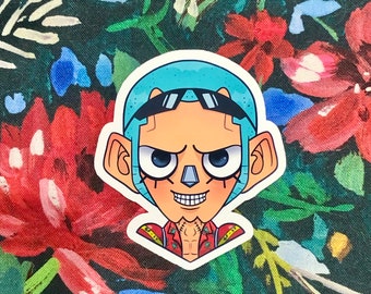 May include: A sticker featuring a cartoon character with light blue hair, black sunglasses, and a stern expression. The character has a tan complexion, a square jaw, and a red and yellow patterned shirt. The background is a dark floral pattern.