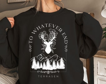 May include: Black sweatshirt with a white graphic design featuring a deer with antlers, flowers, and mountains. The text "To Whatever End" is written in a circle around the deer. The text "Terrassen" is written below the graphic.