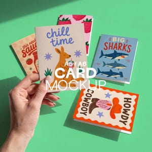 May include: A collection of A5/A6 card mockups with various designs. One card features a kangaroo with the text "chill time". Other cards display images of sharks, a cowboy boot, and a ketchup bottle. The cards are on a green background.