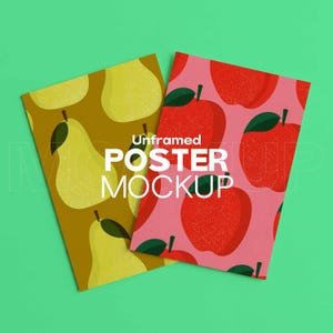 May include: Two unframed poster mockups on a green background. One poster features a pattern of yellow pears on a brown background. The other poster has a pattern of red apples on a pink background. The text "Unframed POSTER MOCKUP" is visible.