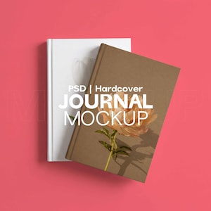 May include: Two hardcover journals, one white and one brown, are displayed on a pink background. The brown journal features a floral design. The text "PSD | Hardcover JOURNAL MOCKUP" is overlaid on the image.