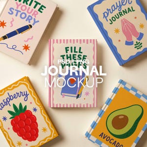 May include: A collection of colorful journals with various designs and text. One journal reads "Write Your Story" with a pen illustration. Another says "Prayer Journal" with praying hands. Other journals feature a raspberry and an avocado.
