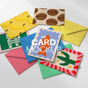 May include: A collection of colorful A6 card mockups with various designs, including bananas, coffee beans, a cactus, and a fish. The cards are surrounded by matching colored envelopes in pink, blue, yellow, and green. The text "CARD MOCKUP" is displayed on one of the cards.