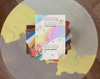 Puede incluir: Un libro para colorear de temática de unicornio con el título "Einhorn Zauber" y el texto "Die bunte Welt der Fantasie" y "Malbuch fur kleine Traumtanzer".