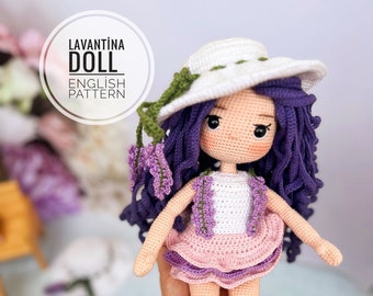 May include: Crocheted doll with purple hair, a white hat, and a pink dress. The doll is holding a bouquet of lavender flowers. The doll is labeled "Lavantina Doll English Pattern" and "Seyhan Basar Design".