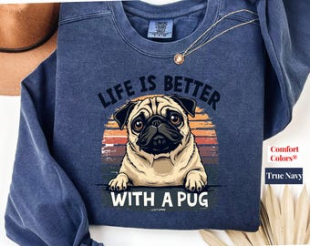 May include: A navy blue sweatshirt with a vintage-style graphic of a pug dog. The text "Life is better with a pug" is printed on the sweatshirt.