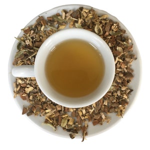 Close up of loose leaf herbal tea blend with dried botanicals in bowl, aromatic calming tea for relaxing evening routine and cozy tea moments